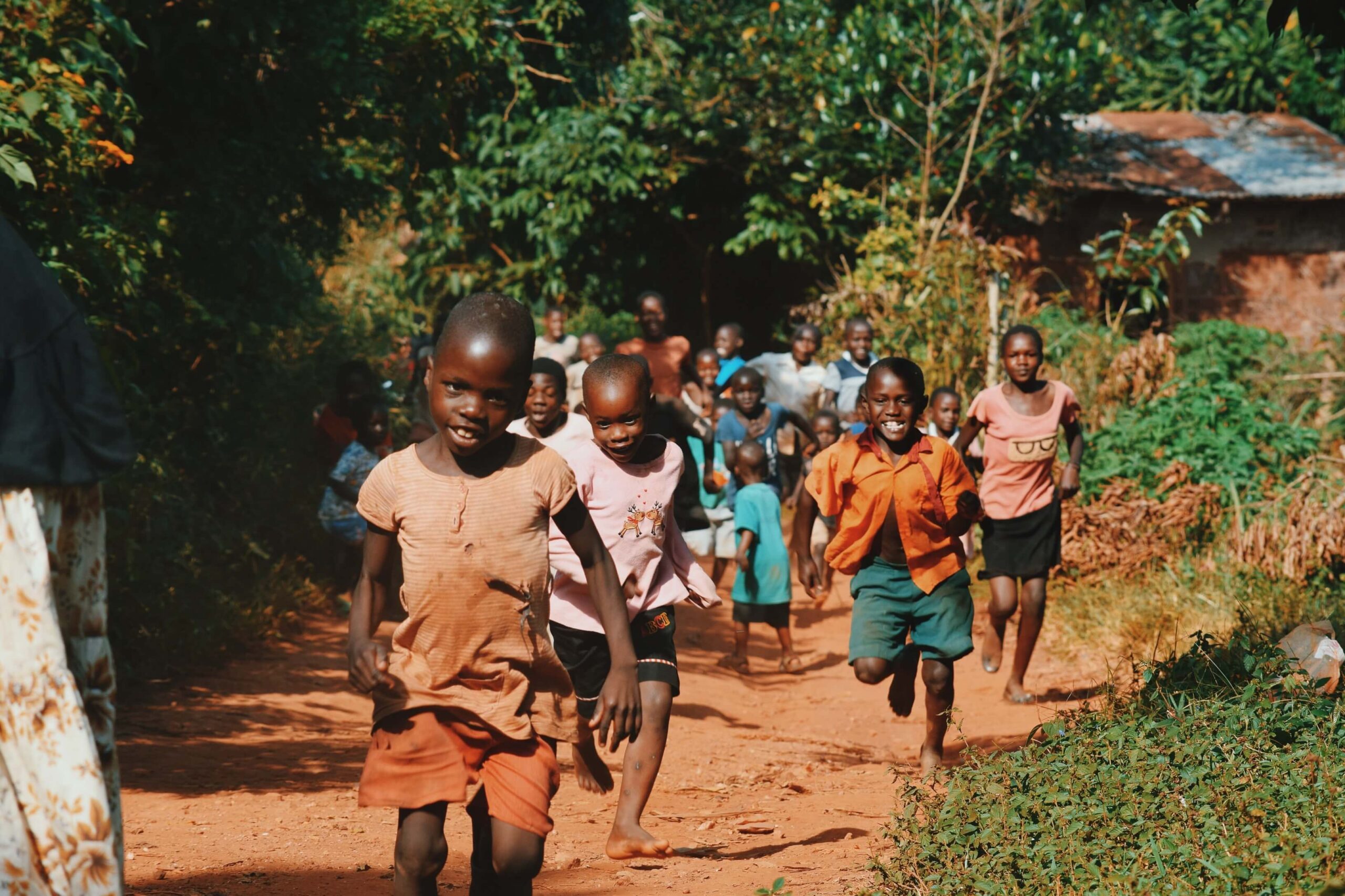 Children running together along a rural path